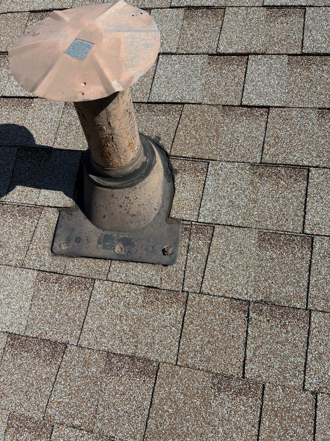 Weathered roof pipe and old pipe boot before replacement