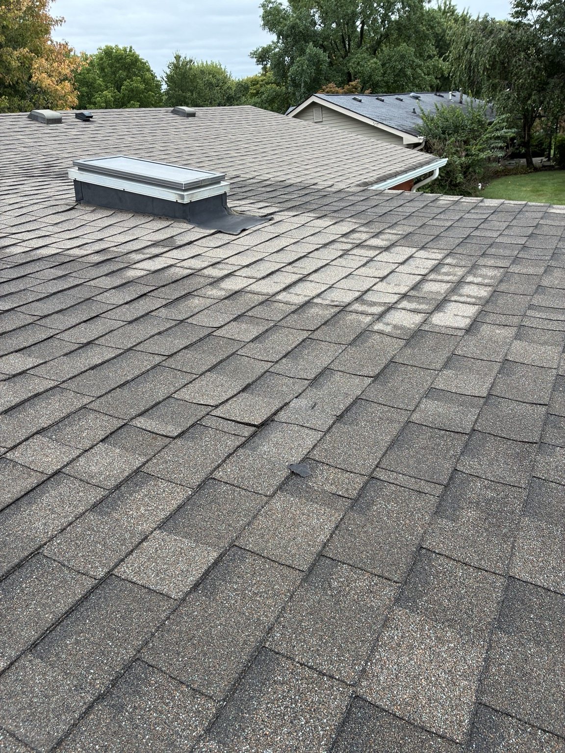 Shingle roof and skylight before the damaged roof area was opened